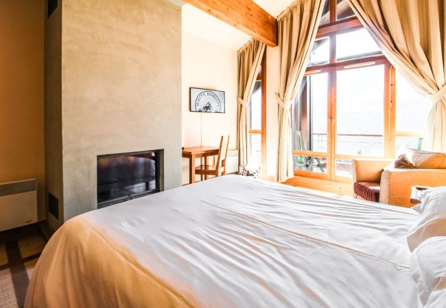 Flaine ski rental - large bedroom with fireplace and mountain views