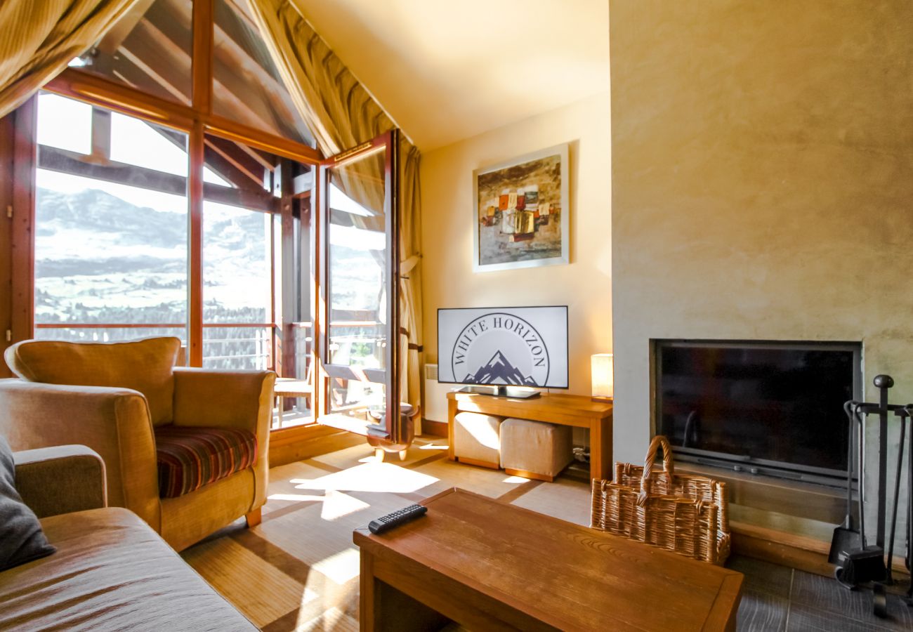 Flaine ski rental - large living room with fireplace and mountain views