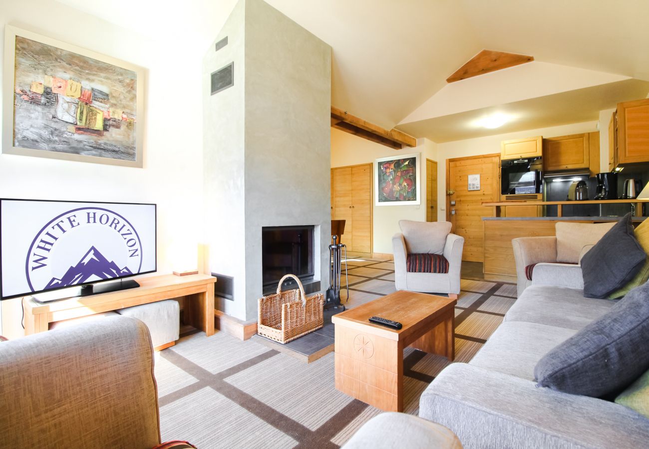 Flaine ski rental - large living room with fireplace and mountain views